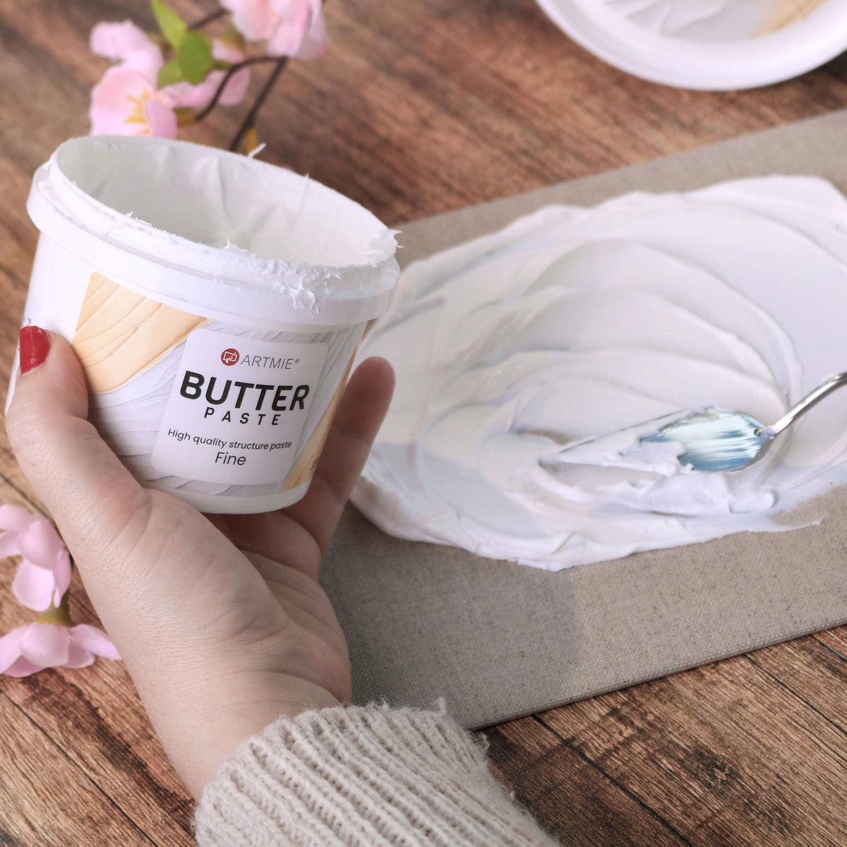 Găletușă deschisă și strat de pastă ARTMIE Butter Fine aplicat pe pânză cu cuțit de paletă